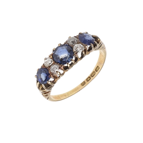 1073 - AN ANTIQUE SAPPHIRE AND DIAMOND RING. the three graduated circular-cut sapphires are set with four o... 