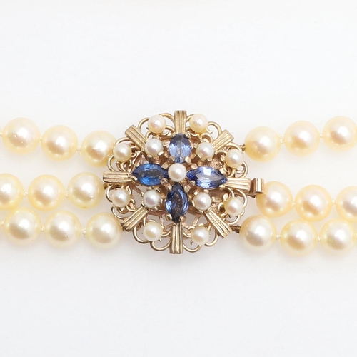 1080 - A THREE ROW CULTURED PEARL NECKLACE. mounted with uniform cultured pearls measuring approximately 7.... 