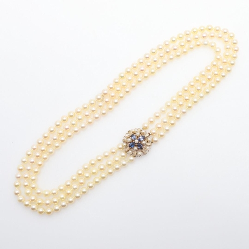 1080 - A THREE ROW CULTURED PEARL NECKLACE. mounted with uniform cultured pearls measuring approximately 7.... 