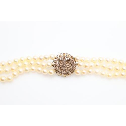 1080 - A THREE ROW CULTURED PEARL NECKLACE. mounted with uniform cultured pearls measuring approximately 7.... 