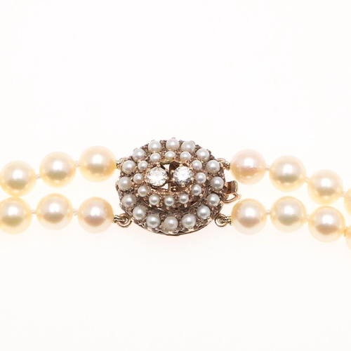 1082 - A DOUBLE ROW CULTURED PEARL CHOKER. the pearls measure approximately 7.6mm and are set to a 9ct gold... 