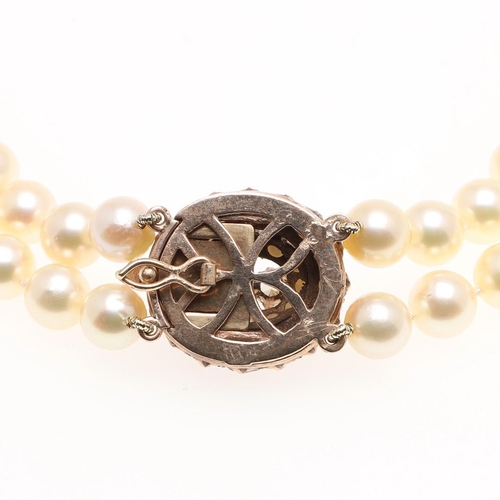 1082 - A DOUBLE ROW CULTURED PEARL CHOKER. the pearls measure approximately 7.6mm and are set to a 9ct gold... 