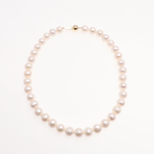 1083 - A SINGLE ROW UNIFORM CULTURED PEARL NECKLACE. the pearls measure approximately 12.0mm and are set to... 