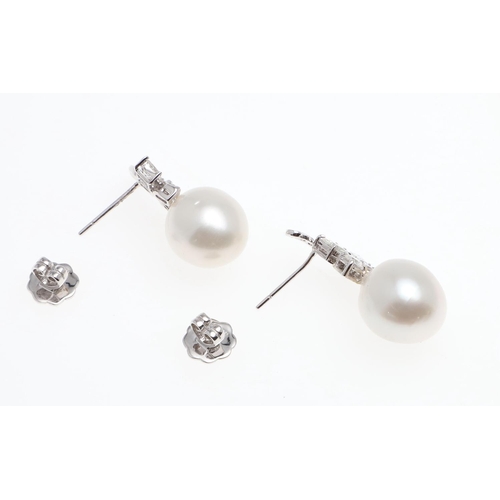 1090 - A PAIR OF DIAMOND AND CULTURED PEARL DROP EARRINGS. each earring set with a cultured pearl measuring... 