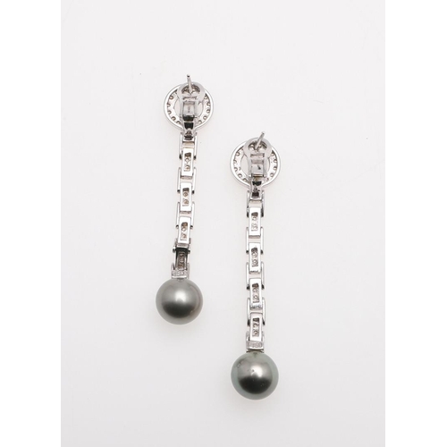 1094 - A PAIR OF DIAMOND AND CULTURED PEARL DROP EARRINGS. each earring formed with a flexible white gold d... 