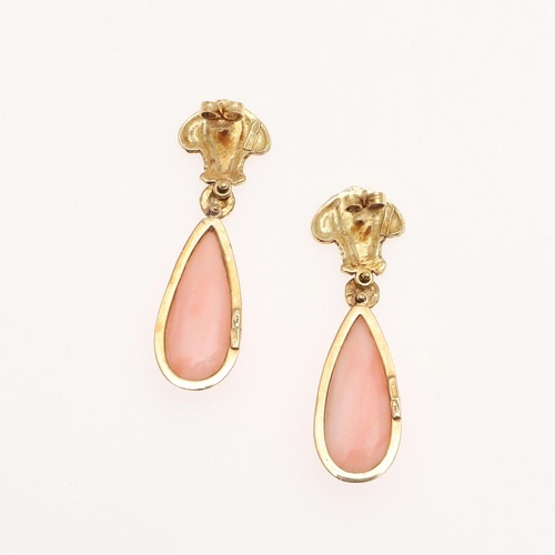 1095 - A PAIR OF CORAL AND GOLD DROP EARRINGS. each earring mounted with a pear-shaped coral drop suspended... 