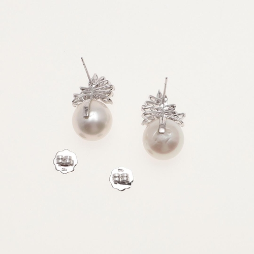 1106 - A PAIR OF CULTURED PEARL AND DIAMOND EARRINGS. the large cultured pearl surmounted by a spray of mar... 