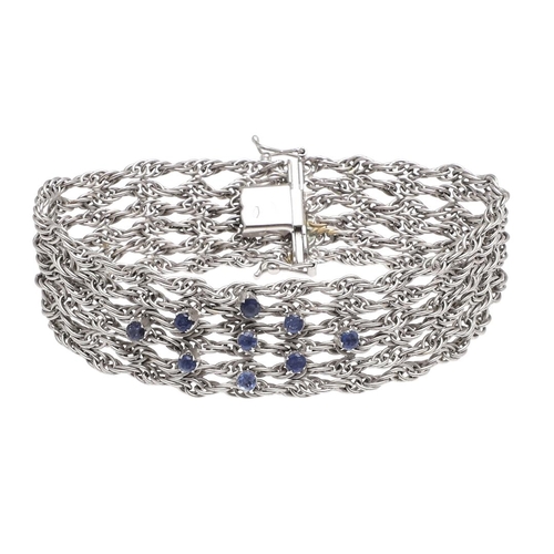 1107 - AN 18CT WHITE GOLD AND SAPPHIRE BRACELET. the woven link gold bracelet is mounted with nine circular... 