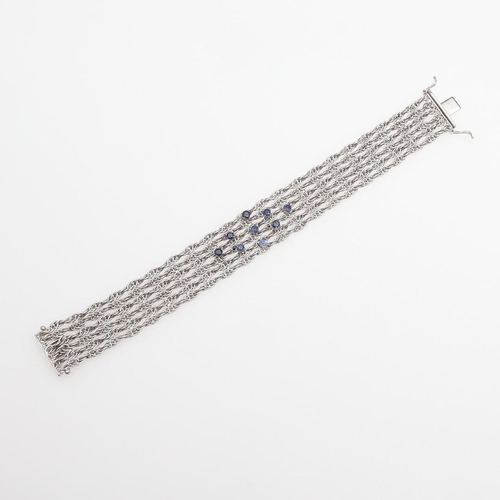 1107 - AN 18CT WHITE GOLD AND SAPPHIRE BRACELET. the woven link gold bracelet is mounted with nine circular... 