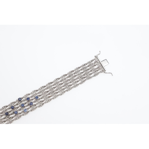 1107 - AN 18CT WHITE GOLD AND SAPPHIRE BRACELET. the woven link gold bracelet is mounted with nine circular... 