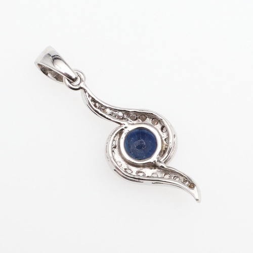 1109 - A SAPPHIRE AND DIAMOND PENDANT. the circular-cut sapphire is set within a surround of brilliant-cut ... 