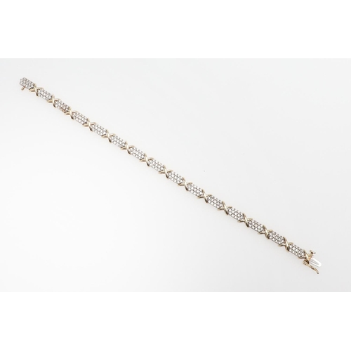 1111 - A DIAMOND AND GOLD BRACELET. formed alternately with sections of circular-cut diamonds and a gold cr... 