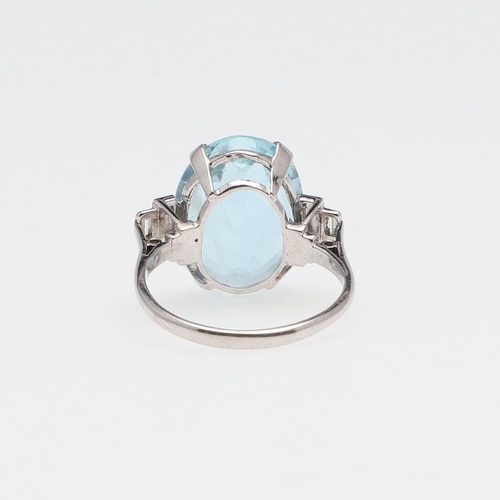 1117 - AN AQUAMARINE AND DIAMOND RING. the oval-shaped aquamarine is set with two baguette-cut diamonds to ... 