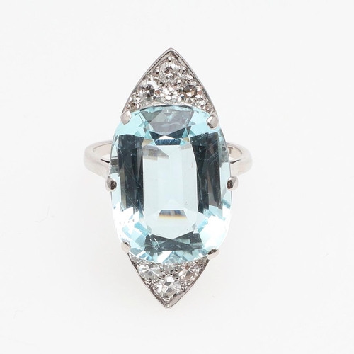 1121 - AN AQUAMARINE AND DIAMOND RING. the oval-shaped aquamarine is set with six graduated circular-cut di... 