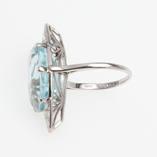 1121 - AN AQUAMARINE AND DIAMOND RING. the oval-shaped aquamarine is set with six graduated circular-cut di... 