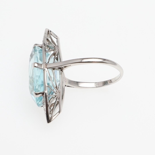 1121 - AN AQUAMARINE AND DIAMOND RING. the oval-shaped aquamarine is set with six graduated circular-cut di... 