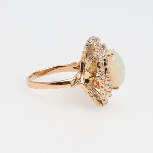 1122 - AN OPAL AND DIAMOND CLUSTER RING. the oval-shaped solid white opal is set within a double surround o... 