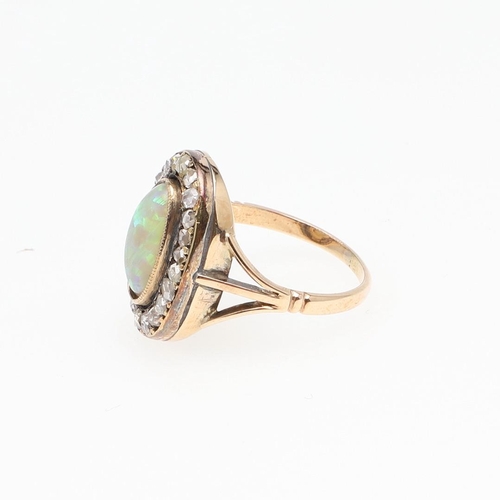 1124 - AN OPAL AND DIAMOND CLUSTER RING. the oval-shaped solid white opal is set within a surround of rose-... 