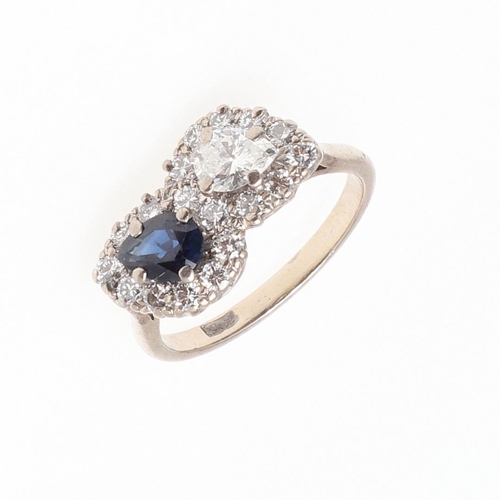 1129 - A SAPPHIRE AND DIAMOND DOUBLE CLUSTER RING. set with a pear-shaped diamond and sapphire each set wit... 