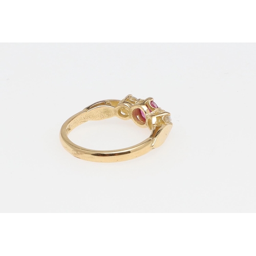 1134 - A RUBY AND DIAMOND THREE STONE RING. the circular-cut ruby is set with two brilliant-cut diamonds, i... 