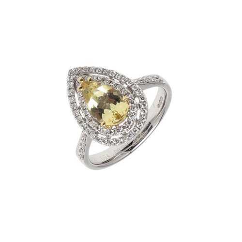 1136 - A GOLDEN BERYL AND DIAMOND CLUSTER RING. the pear-shaped beryl measures 1.34 carats and is set withi... 