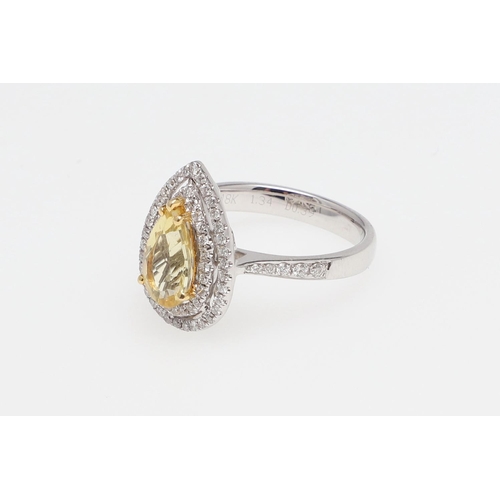 1136 - A GOLDEN BERYL AND DIAMOND CLUSTER RING. the pear-shaped beryl measures 1.34 carats and is set withi... 