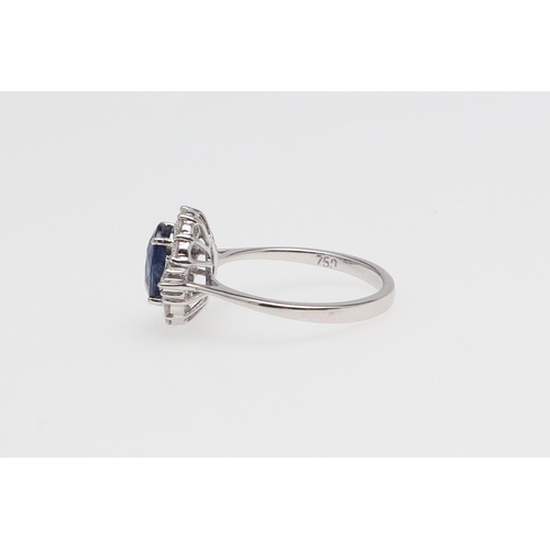 1138 - A SAPPHIRE AND DIAMOND CLUSTER RING. the oval-shaped sapphire weighs 2.34 carats and is set within a... 