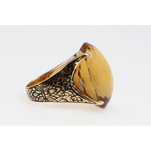 1142 - A LARGE CITRINE DRESS RING. the large oval faceted citrine set in 18ct gold with black enamelled sho... 