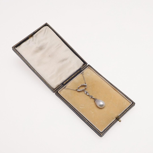 1148 - AN EDWARDIAN NATURAL PEARL AND DIAMOND PENDANT. the natural pearl drop is suspended from a foliate l... 