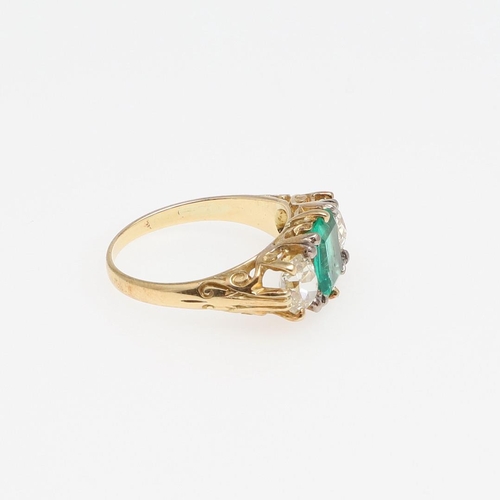 1151 - A COLOMBIAN EMERALD AND DIAMOND THREE STONE RING. the rectangular-shaped emerald is set with two cus... 