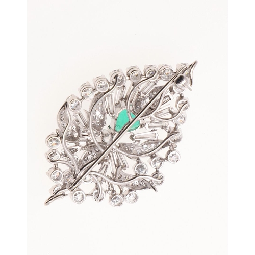 1160 - AN EMERALD AND DIAMOND LEAF BROOCH. The modern, stylized leaf centred with an emerald and set with b... 