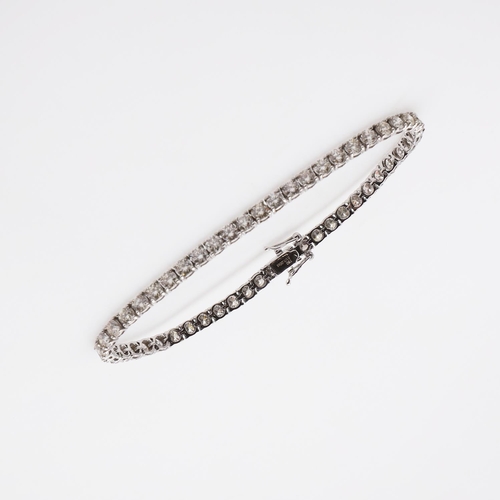 1164 - A DIAMOND LINE BRACELET. claw set with round brilliant-cut diamonds weighing 7.00 carats in total, i... 