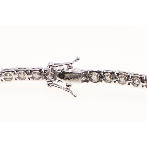 1164 - A DIAMOND LINE BRACELET. claw set with round brilliant-cut diamonds weighing 7.00 carats in total, i... 