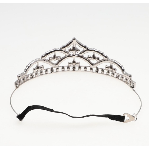 847 - A PASTE SET TIARA. set overall with circular and pear-shaped paste stones, in white metal, 5.0cm hig... 