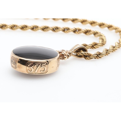 857 - A 9CT GOLD FOB. mounted with black onyx to one side, agate to the other, on a 9ct gold rope link cha... 