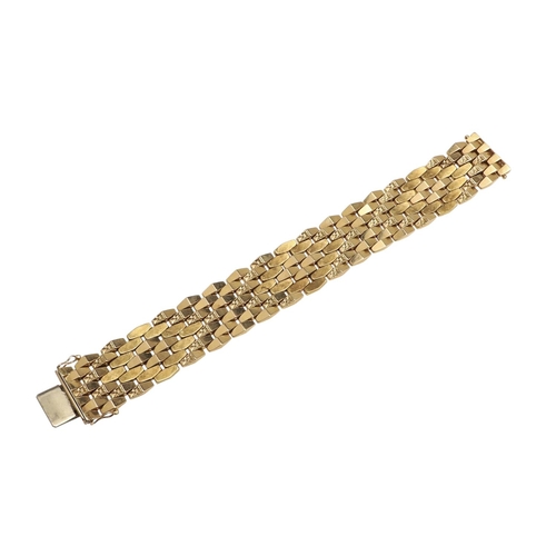 865 - AN 18CT GOLD PANEL BRACELET. formed with undulating plain and foliate engraved links to a concealed ... 