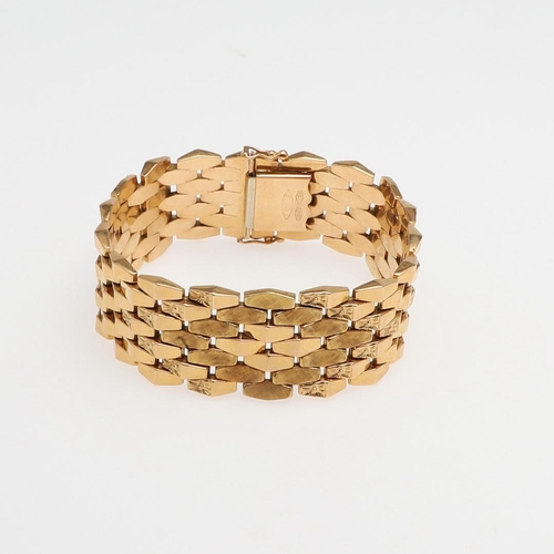 865 - AN 18CT GOLD PANEL BRACELET. formed with undulating plain and foliate engraved links to a concealed ... 