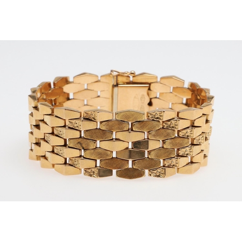 865 - AN 18CT GOLD PANEL BRACELET. formed with undulating plain and foliate engraved links to a concealed ... 