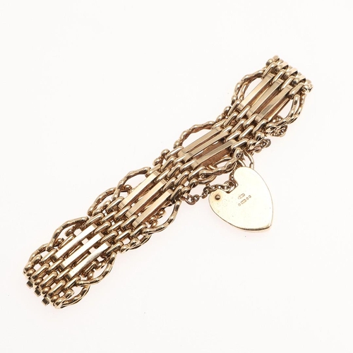 883 - A 9CT GOLD GATE LINK BRACELET. The gate type bracelet with engraved padlock clasp 22.9g.  *Condition... 