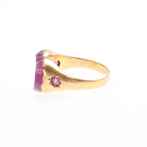 894 - A RUBY AND GOLD SIGNET RING. mounted with a vacant shield-shaped ruby in yellow gold, with a circula... 