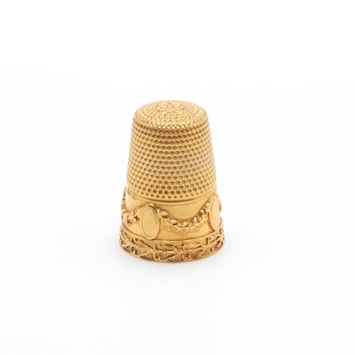 902 - A GOLD THIMBLE. with embossed foliate and swag decoration, 2.3cm high, 5.0 grams.  *Condition:  No o... 