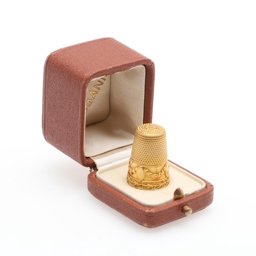 902 - A GOLD THIMBLE. with embossed foliate and swag decoration, 2.3cm high, 5.0 grams.  *Condition:  No o... 