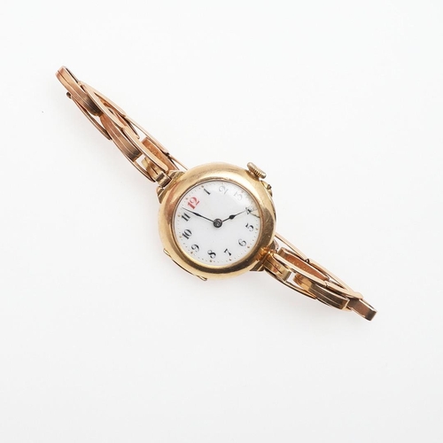 932 - AN 18CT GOLD WRISTWATCH. the white enamel dial with black Arabic numerals, one red at 12 o'clock, on... 