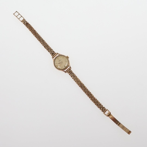 934 - A LADY'S 9CT GOLD WRISTWATCH BY OMEGA. the signed square-shaped dial with baton numerals, the winder... 