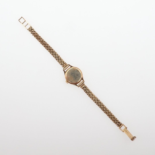 934 - A LADY'S 9CT GOLD WRISTWATCH BY OMEGA. the signed square-shaped dial with baton numerals, the winder... 