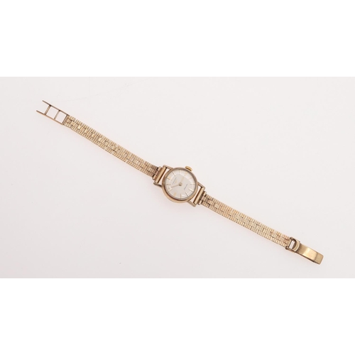 935 - A LADY'S 9CT GOLD WRISTWATCH BY LONGINES. the signed circular dial with baton numerals, Longines log... 