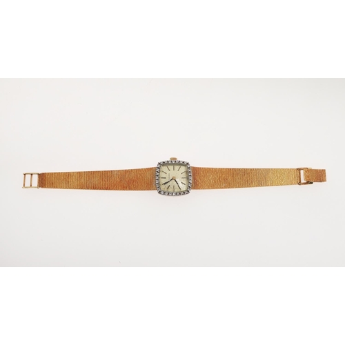 938 - A LADY'S 18CT GOLD AND DIAMOND WRISTWATCH BY LONGINES. the signed cushion-shaped dial with baton num... 