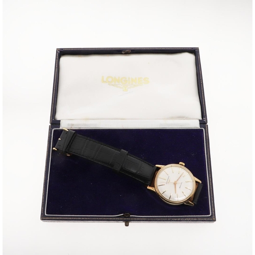 955 - A GENTLEMAN'S GOLD AUTOMATIC WRISTWATCH BY LONGINES. the signed circular dial with baton numerals, r... 