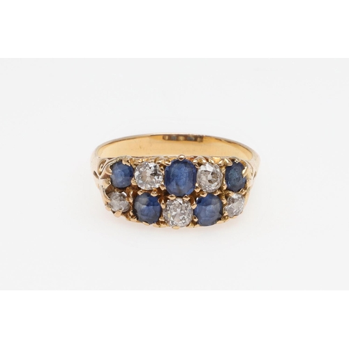 968 - A SAPPHIRE AND DIAMOND TWO ROW RING. alternately set with circular-cut sapphires and circular old-cu... 