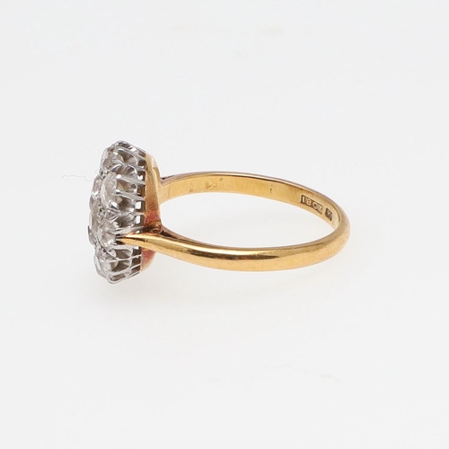 969 - A DIAMOND CLUSTER RING. millegrain set with graduated round old-cut diamonds, in 18ct gold and plati... 